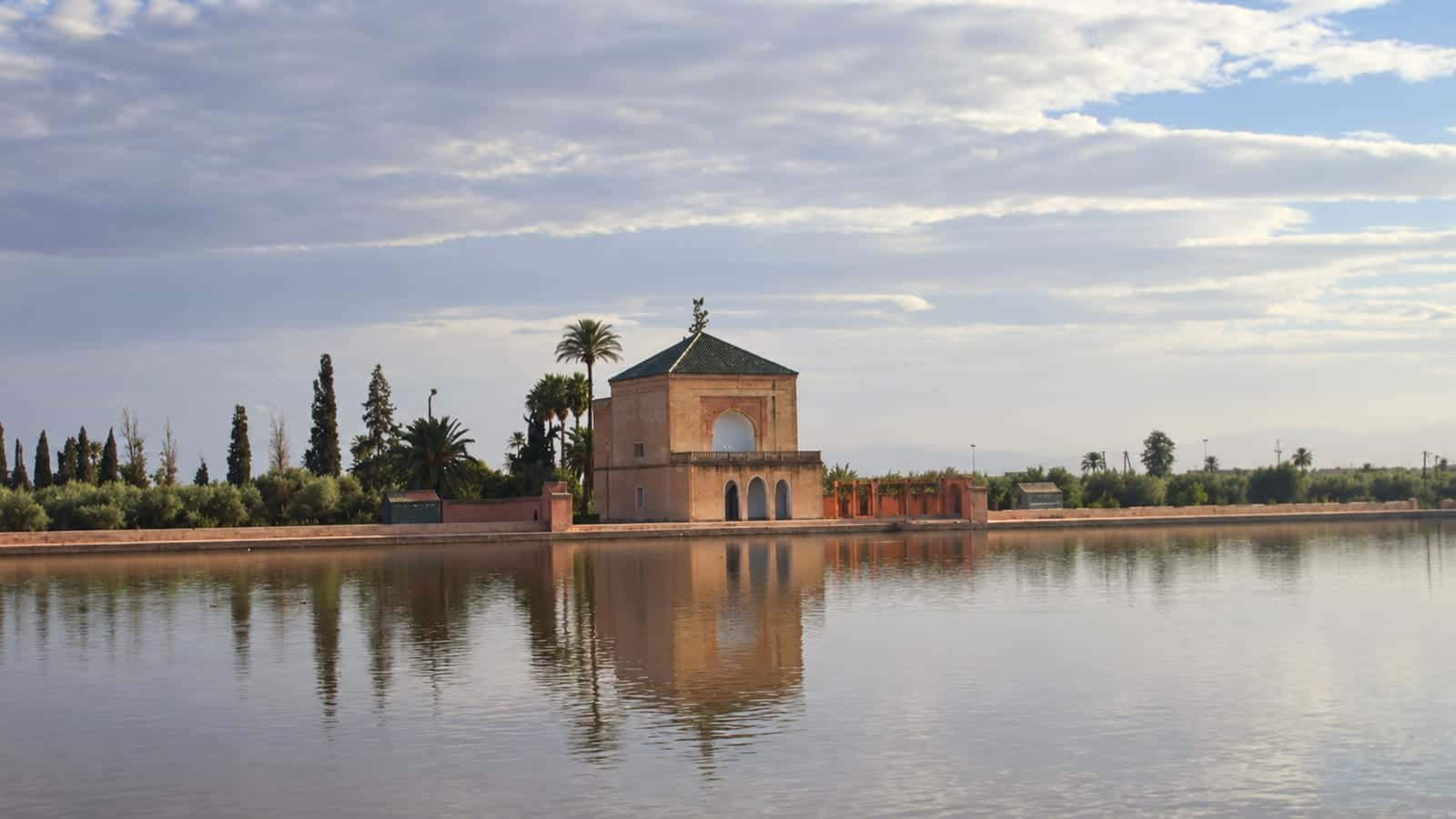The green-roofed Menara pavilion and its reflection in the reservoir in Marrakech